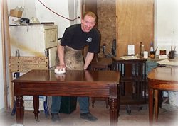 Neil Busby restoring an antique mahogany table